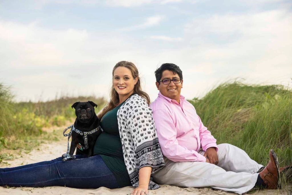 Expecting parents on Galveston beach TX with dog