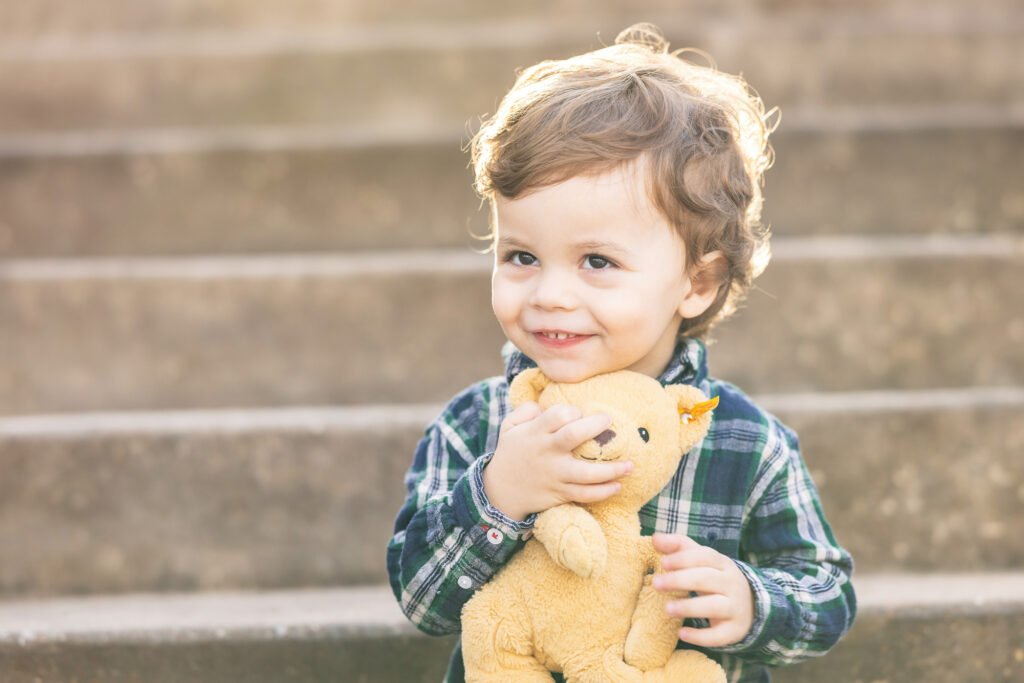 Two year old with toy bear in Houston TX