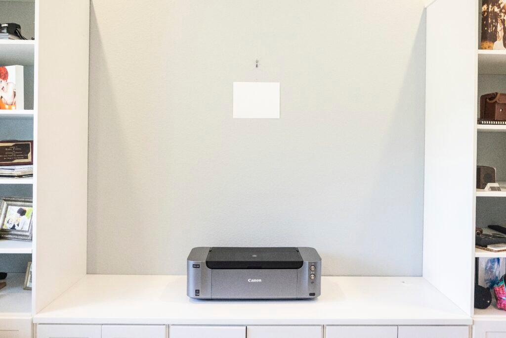 By putting a piece of white paper on any wall, we can show a client exactly what a piece of wall art will look correctly sized. Kara Powell Photography.